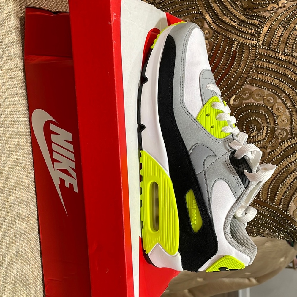 Nike Air Max sneaker with neon green swoosh.
